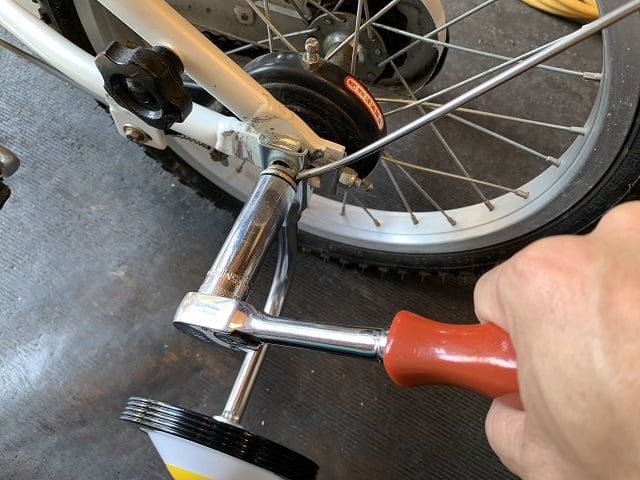 自転車補助輪をナットを工具で締めて固定